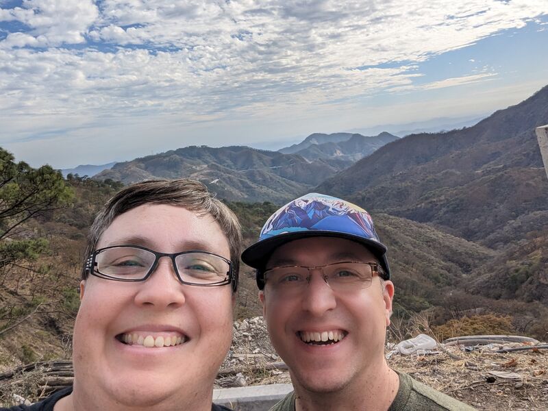 We like taking selfies, okay?!  Lenore and I are *very* much in the foreground while in the background you can see a stunning view of the mountains.