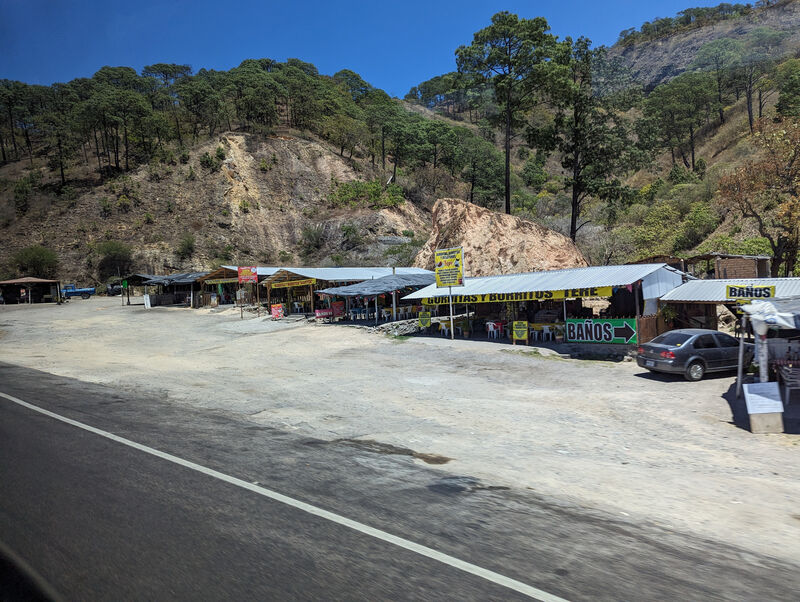 In the photo, which I actually took on our return back from Durango, is a row of little open-air roadside eateries serving gorditas, burritos, empanadas, and so forth. Ours is the one with the red writing on a yellow background.
